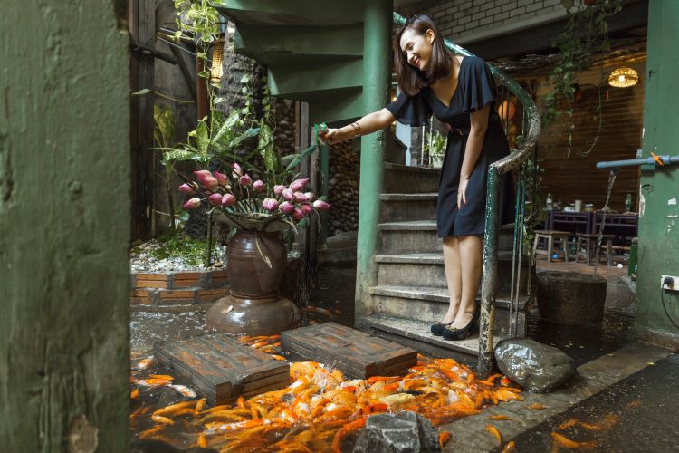 Diễn viên Lã Thanh Huyền hứng thú cho cá ăn tại Ao Quán